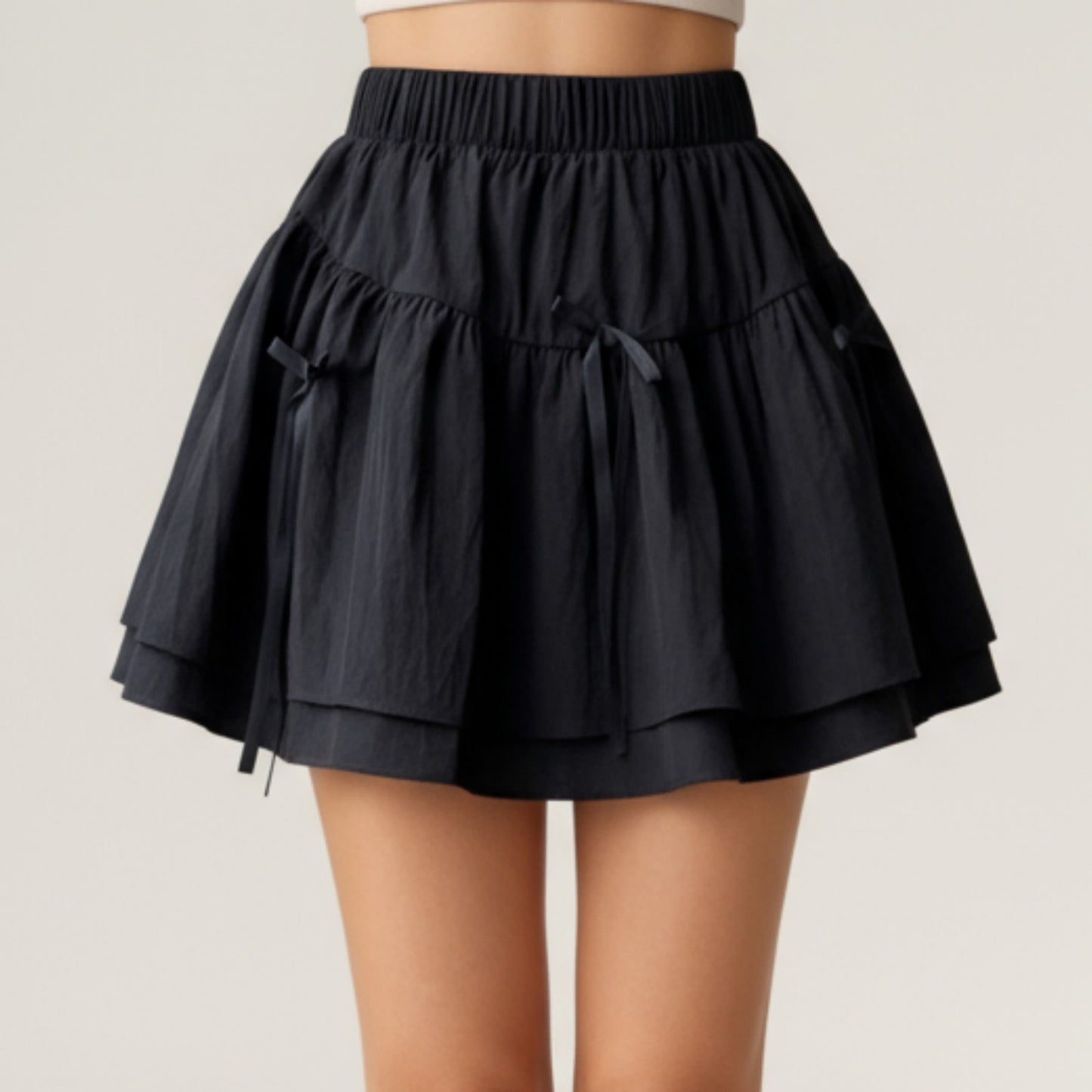 Tiered Mini Skirt with Layered Ruffle Hem and Delicate Bow Accents in Soft Lightweight Fabric