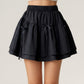 Tiered Mini Skirt with Layered Ruffle Hem and Delicate Bow Accents in Soft Lightweight Fabric