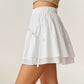 Tiered Mini Skirt with Layered Ruffle Hem and Delicate Bow Accents in Soft Lightweight Fabric