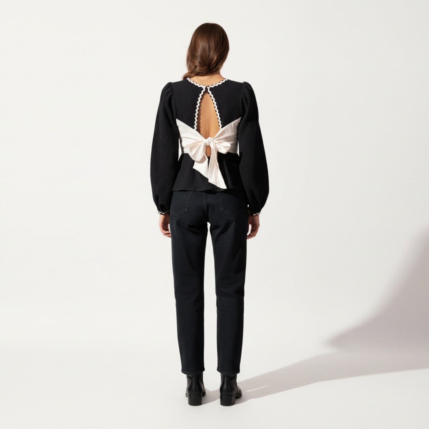 Long Sleeve Textured Peplum Top with Contrast Trim Accents and Statement Bow Detail