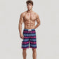 Men's Vibrant Stripe Swim Trunks with Wave-Inspired Pattern and Drawstring Waistband in Quick-Dry Fabric