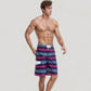 Men's Vibrant Stripe Swim Trunks with Wave-Inspired Pattern and Drawstring Waistband in Quick-Dry Fabric